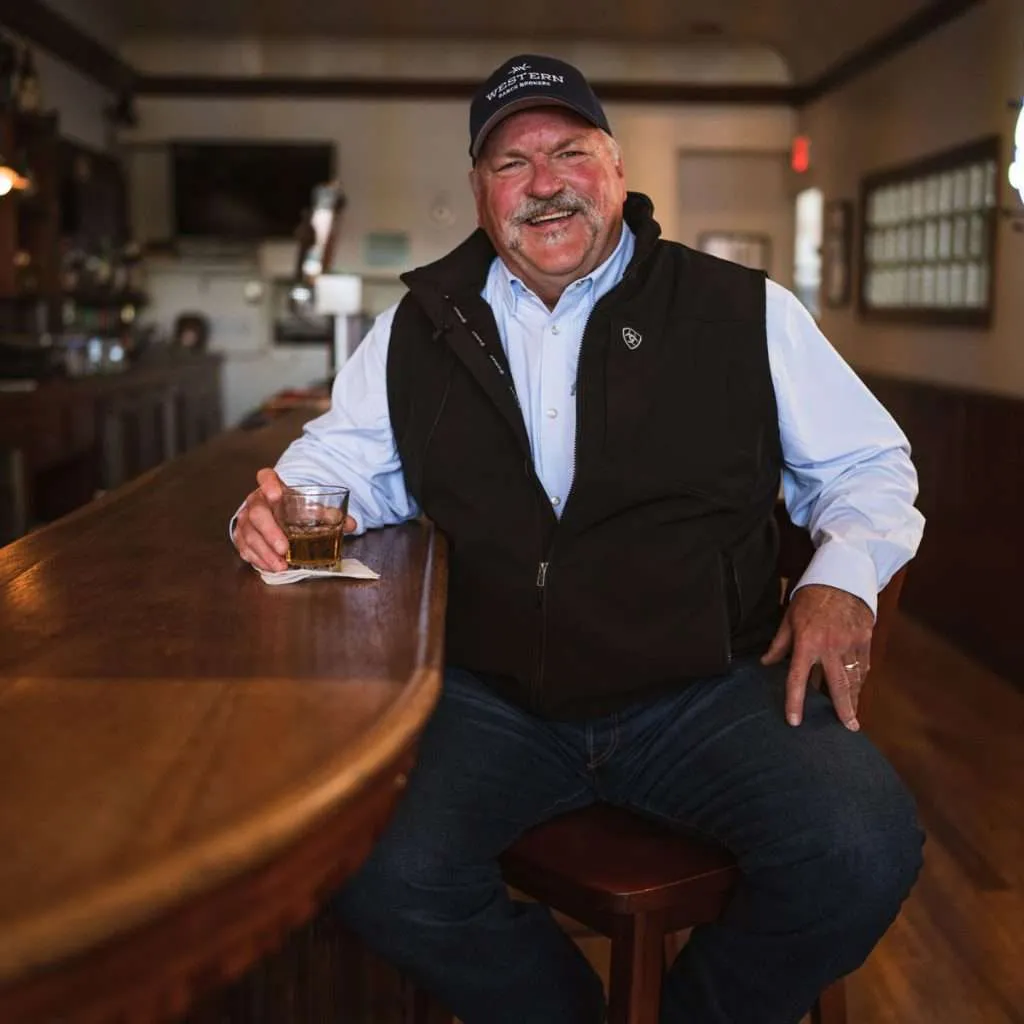 Man Sitting At Bar with Drink - Western Ranch Brokers Man Sitting At Bar with Drink