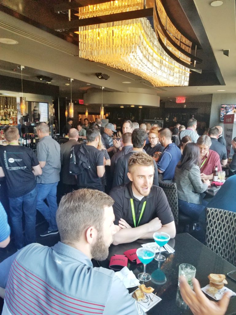 Crowded customer happy hour at Morton's Steakhouse during Citrix Synergy 2018, with guests at the bar and tables