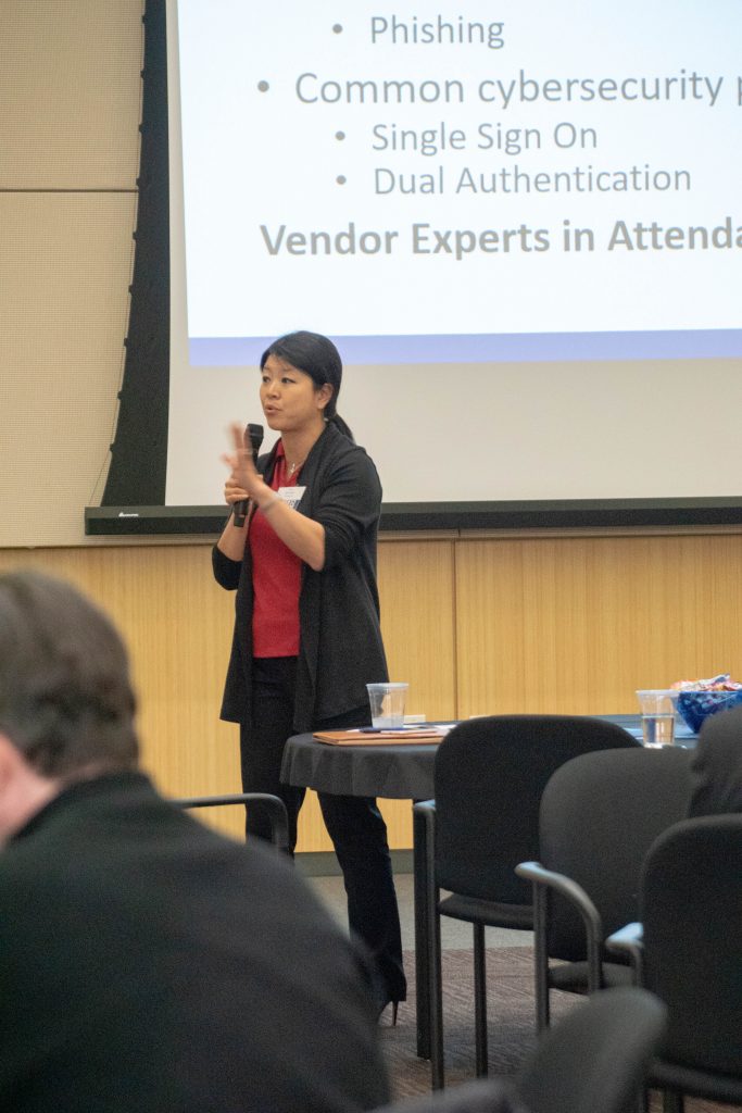 Cyber Security breakout moderator speaking in front of a slide on phishing, single sign-on and dual authentication