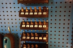 Screwdriver bits holder for a pegboard
