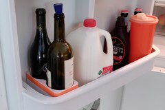 Wine holder for fridge door shelf